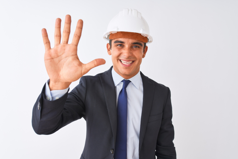 Young handsome architect man wearing suit and helmet over isolated white background showing and pointing up with fingers number five while smiling confident and happy.