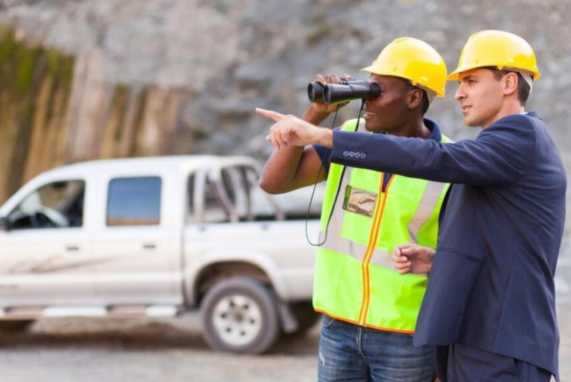Site manager and Construction worker monitoring the building site