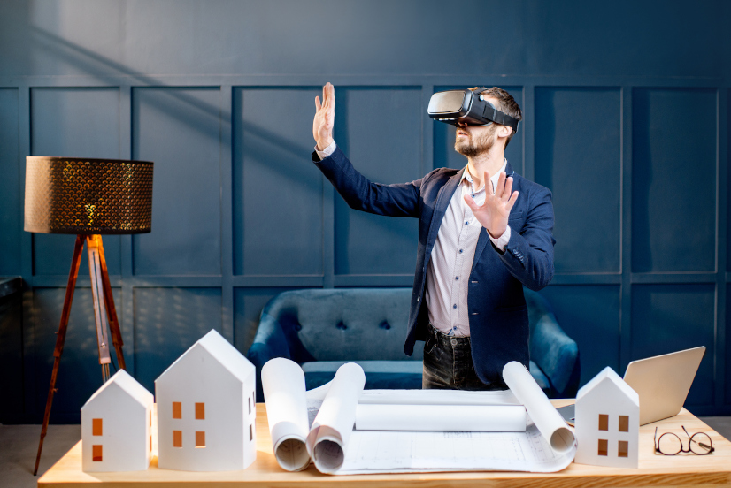 Elegant man as an architect or client imagining architectural project with virtual reality glasses standing at the working place in the luxury office