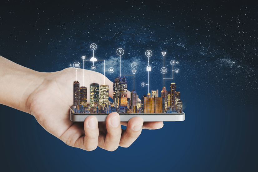 Smart city, building technology and mobile application technology. Hand holding mobile smart phone with buildings hologram and application programming interface technology