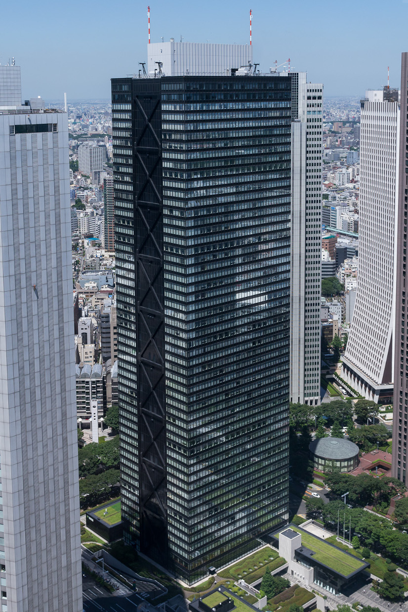 A photograph of the Shinjuku Mitsui Building, a glass skyscraper in Tokyo