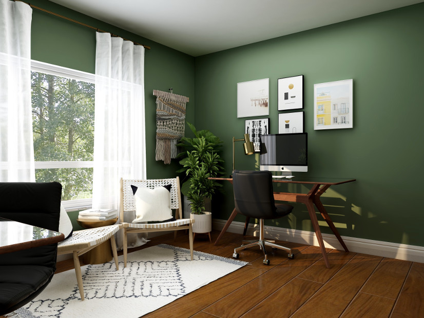 A home office with dark green walls and a calm atmosphere.